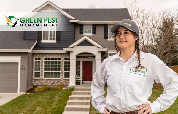 Green Pest Management pest control technician standing in front of residence.