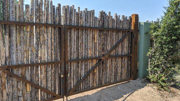 Our beautiful new gate blends right in with the existing fence.