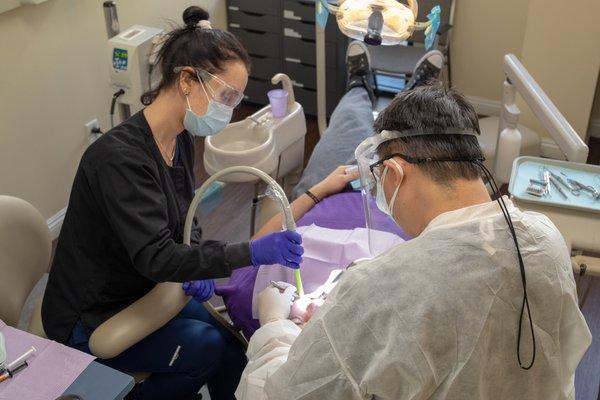 Dr. Wong, hard at work restoring a patient's wonderful smile