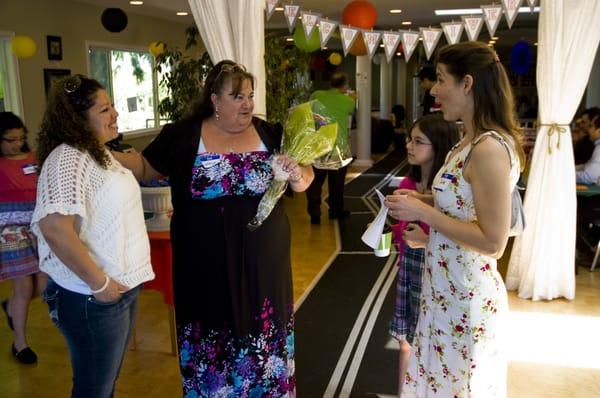 Kathlyn holds flowers received from a driving school graduate.