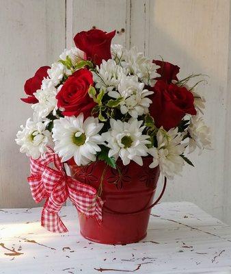 Fresh cut flowers in a red tin