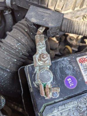 Corroded battery terminal before being fixed.