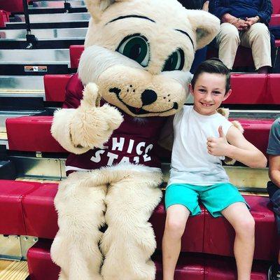 Dancer and the Chico State Wildcat Mascot give a thumbs up for the performance at halftime at the men's basketball game!