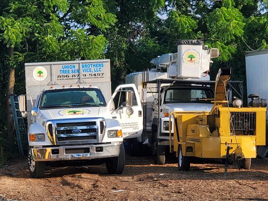 Two Union Brothers Tree Service trucks and their chipper.