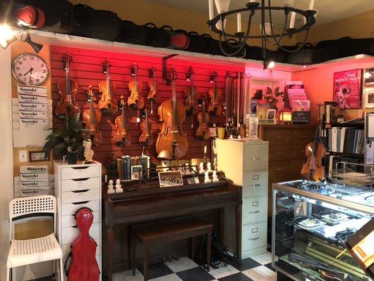 Violin Shop at Wild Roots Fine Arts.