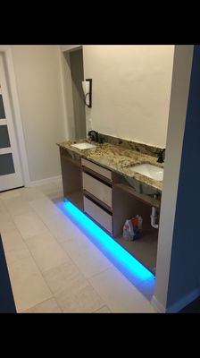 Custom built free standing vanity with LED color changing lighting under vanity.