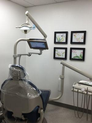 treatment room with chair-mounted TV for customer to enjoy