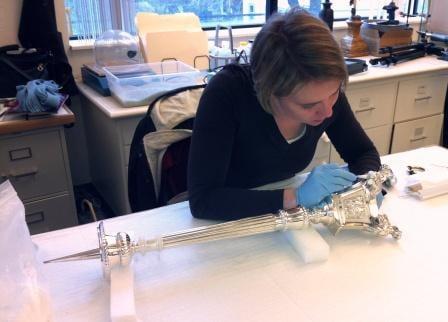 Cleaning one of a set of enormous silver candlesticks