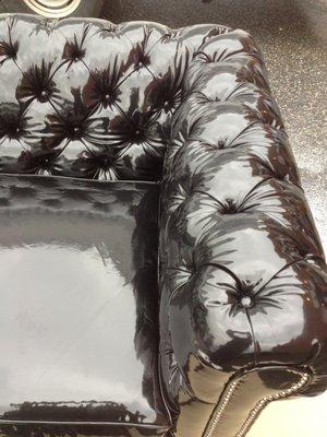 Custom tufted sofa in black patent leather