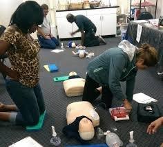 Students learning how to perform CPR and using and AED.