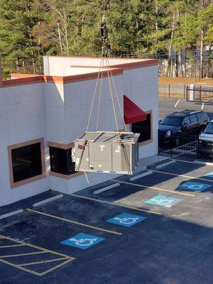 10 ton commercial heat pump unit being lifted for installation in Atlanta.