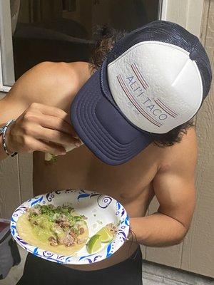 Mejo powering through some tacos rocking the Merch