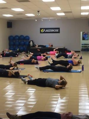 Class is near the end of Dance Mixx doing a floor routine to work the abdominals.  Every class includes strength routines!