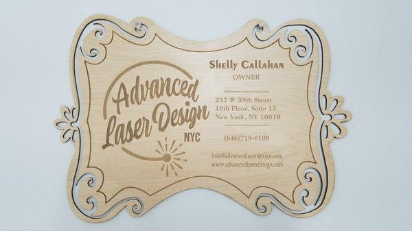 Laser engraved and cut wood laminate sign