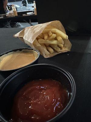 Fries with ketchup and Hawk sauce