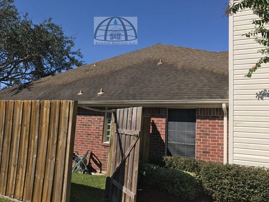 A roof cleaning in progress using our soft wash method.