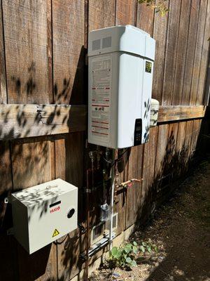 New exterior Navien tankless water heater installed in Mill Valley with back up battery to ensure there is hot water during a power outage.