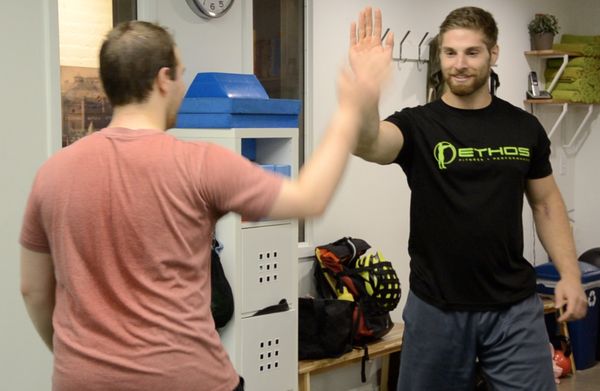 Coach Matt congratulates Luther on a successful set of squats