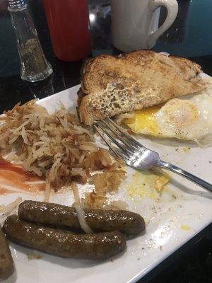 Over easy eggs, hash browns and sausage sourdough bread