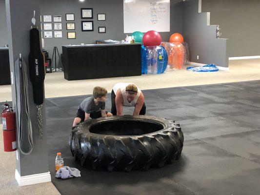 Team Work!!! Mom and son flipping a tire together.