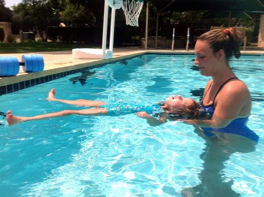 One of our instructors, Miss Allison, working on floating with one of our 3 year olds.