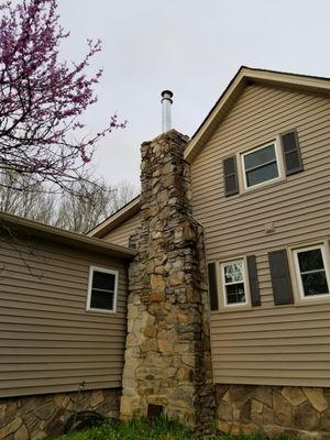 Before of the top portion of an older unfinished stone chimney.