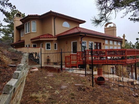 This is a stone coated steel in a tile profile.  The red gives this home a real pop of color.