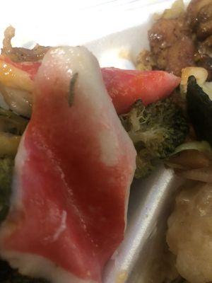 A worm on a piece of imitation crab meat that was in with the Broccoli