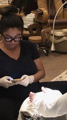 Technician continuously texting during pedicure