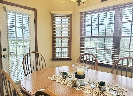 Displayed are corded faux wood blinds in our embossed white tone.