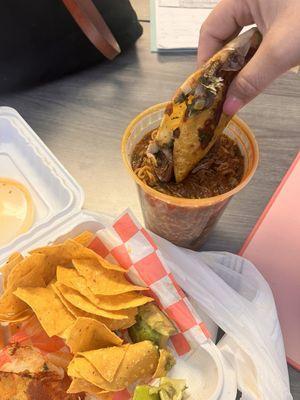 Birria ramen (beef).  Came with two beef tacos, tortilla chips and a couple slices avocado.