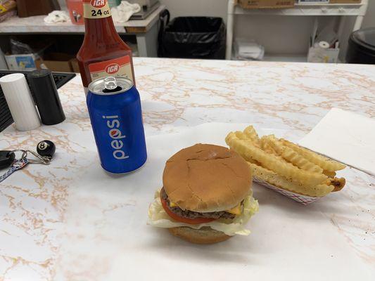 Cheese burger, fries and a Pepsi.