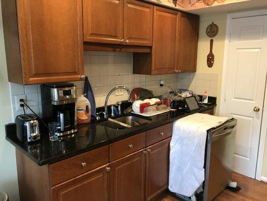 This is what the kitchen looked like before with the old backsplash, dishwasher, and floors.