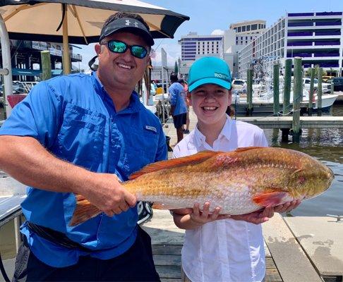 The amazing captain and our daughter who reeled this bad boy in on her own!