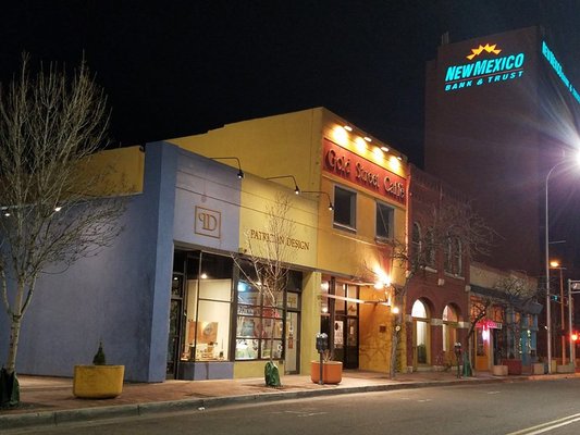 By night, PATRICIAN DESIGN'S STUDIO AND BOUTIQUE GALLERY OF ART AND GIFTS glows on Gold Avenue - downtown.