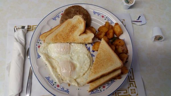 Eggs over easy, home fries, sausage, & toast