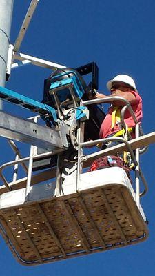 Don Roh installing Altas Sound loudspeakers for a High School football field.