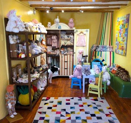 Interior of store. Baby clothes by Milkbarn and Elegant Baby, baby shoes, Jellycat plush animals, and more.