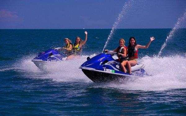 Friends riding rental jet skis, Marathon Bayside