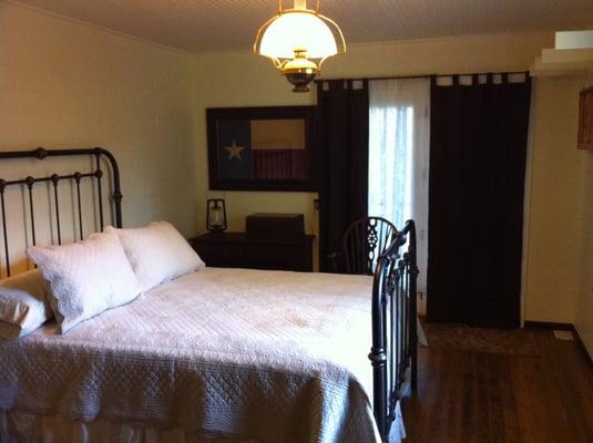 Queen size master bedroom with a door leading to the screened porch.