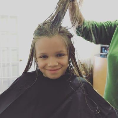 Matinah getting her hair cut.