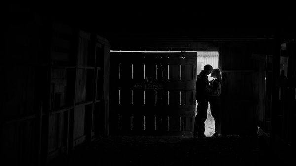 Destination Engagement Photography session in Oklahoma City in the winter on a private farm in the barn in the late afternoon sun.