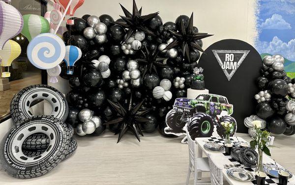 Balloon wall, 8x8. Character cut outs, inflatable tires as accent pieces for the balloon display & tables.