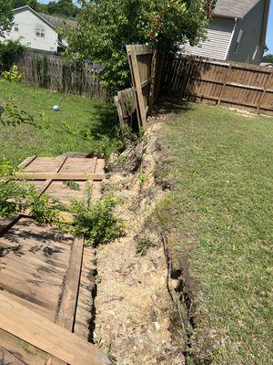 Before retaining wall and fence