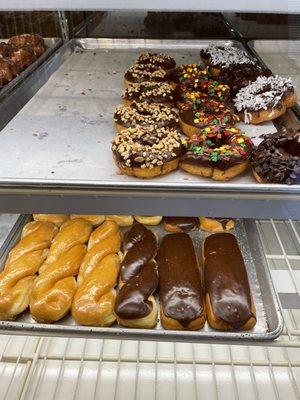 Chocolate glaze donuts with nuts, sprinkles, coconut