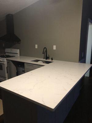 Classical white quarts countertops with beautiful gray veins throughout and true white background,  zero radius corners single bowl sink