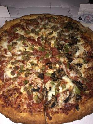 Supreme pizza: mushrooms, peppers, pepperoni, and sausage