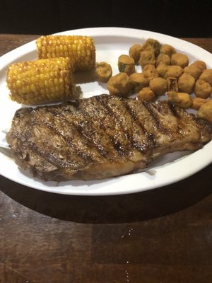 Steak with "fried corn on the cob" and "fried okra".