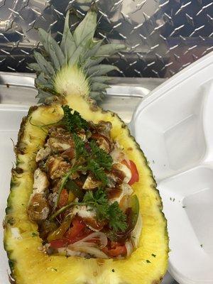 Jerk chicken Rice Pineapple Bowl: Grilled Chicken, yellow rice, mixed peppers & onions with Jerk sauce.