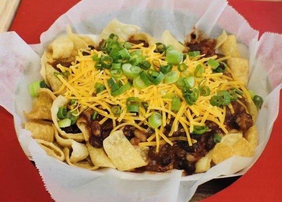 Want the best frito pie you ever had? Try our New Year Walking Taco with New Years Day Chili on wonton chips topped with cheddar and onion.